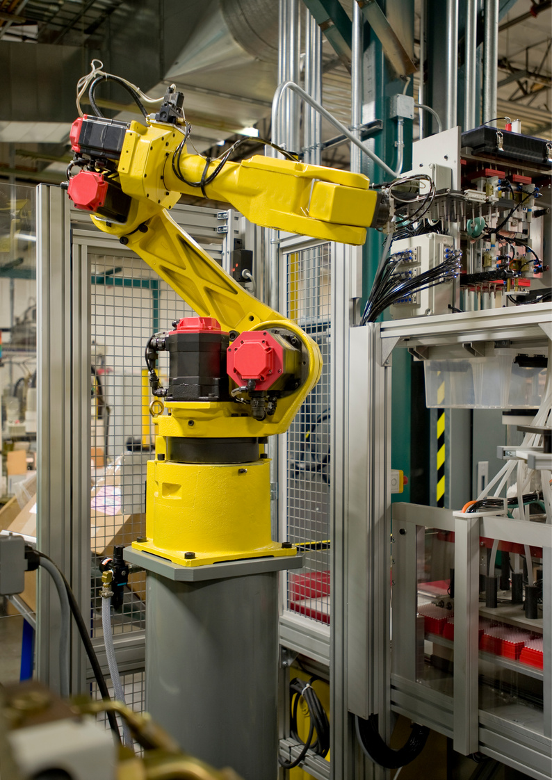Yellow robotic arm operating electric machinery